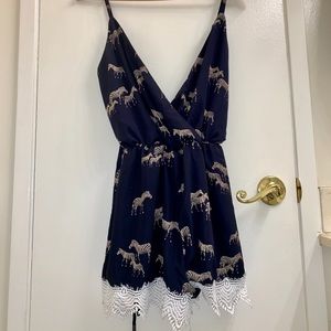 Navy Printed zebra romper with white lace trim